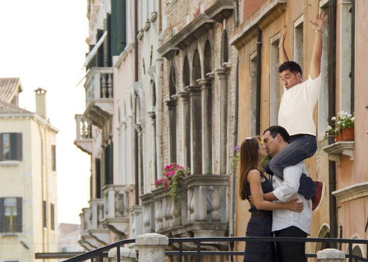 Italy, Venice, Mature couple kissing on bridge