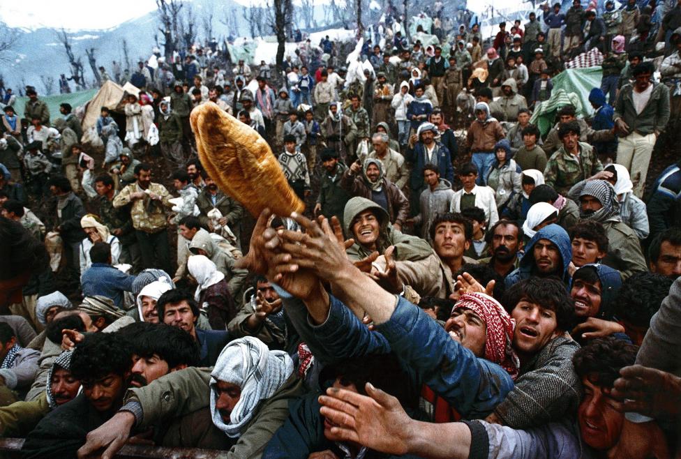 File photo of frantic Kurdish refugees struggling for a loaf of bread during a humanitarian aid distribution for hundreds of thousands of stranded Iraqi-Kurds in the mountains of Isikveren at the Iraqi-Turkish border