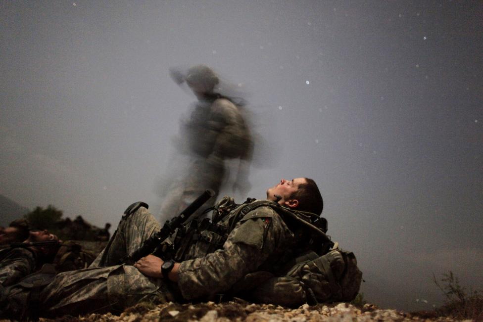 File photo of a U.S. soldier taking a break during a night mission near Honaker Miracle camp at the Pesh valley of Kunar Province