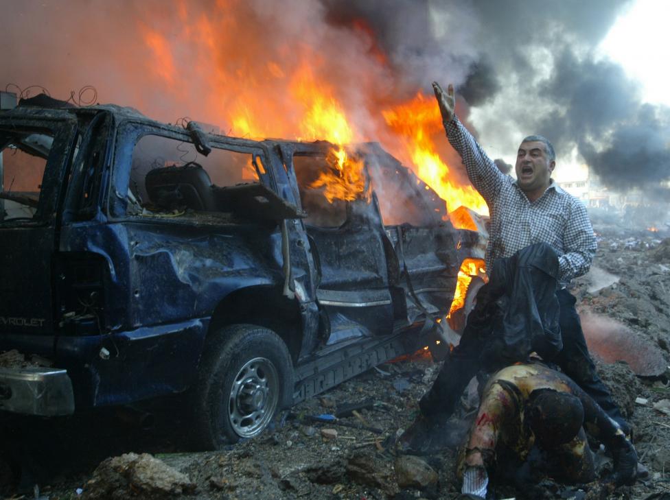 File photo of a Lebanese man shouting for help for a wounded man near the site of a car bomb explosion in Beirut