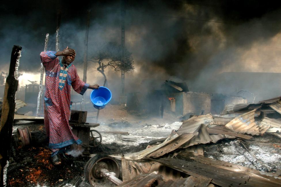 File photo of a man rinsing soot from his face at the scene of a gas pipeline explosion near Nigeria's commercial capital Lagos