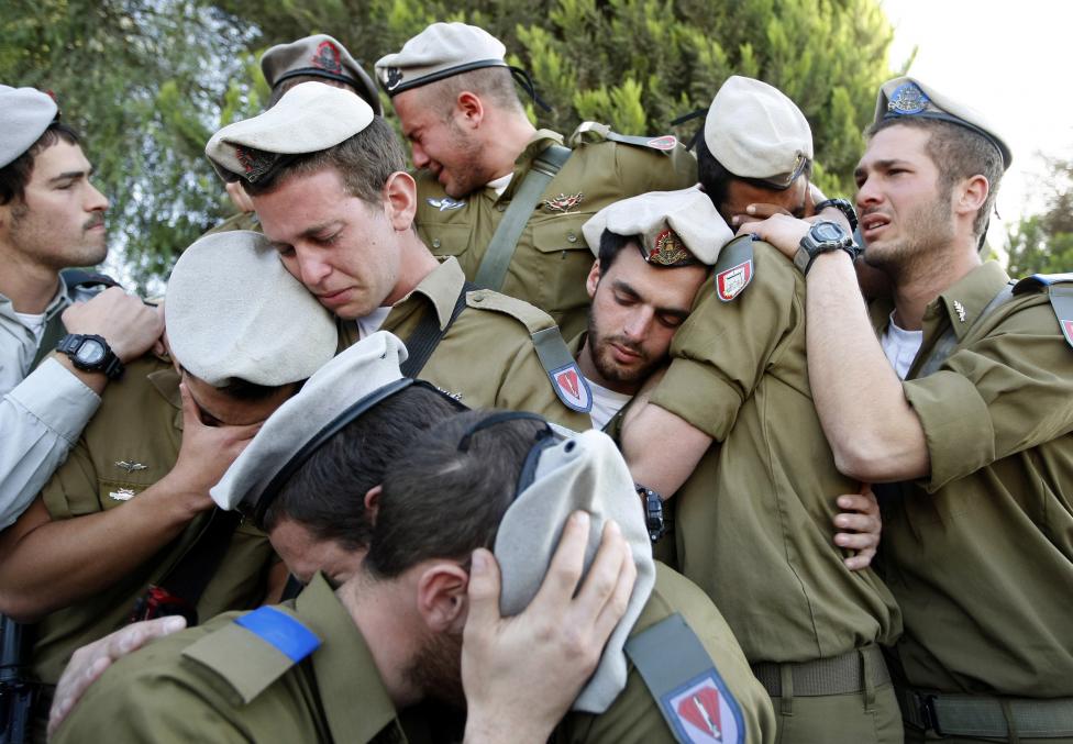 File photo of Israeli soldiers mourning during the funeral of their comrade Alex Mashavisky at a cemetery in Beersheba