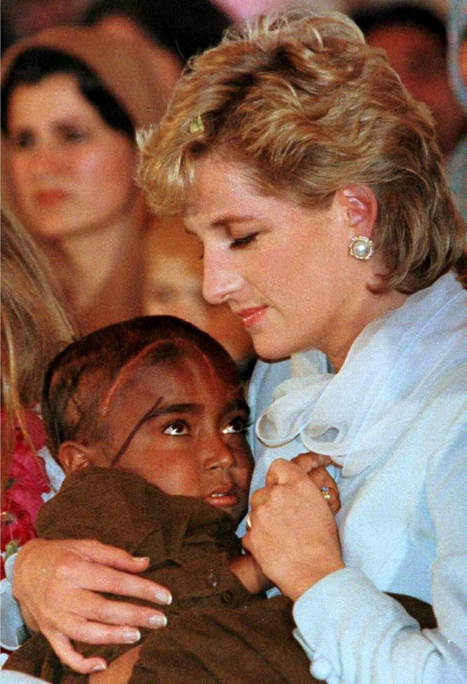 File photo of Diana Princess of Wales cradling a young child stricken with cancer during a show at the Shaukat Khanum Memorial Cancer Hospital in Lahore