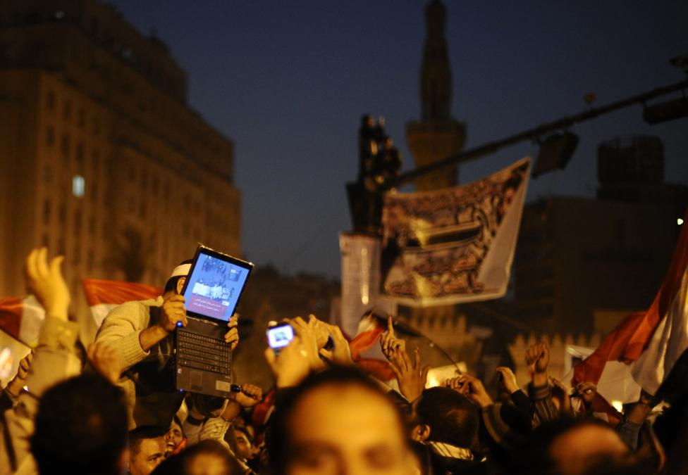 File photo of an opposition supporter holding up a laptop showing images of celebrations in Cairo's Tahrir Square, after Egypt's President Hosni Mubarak resigned