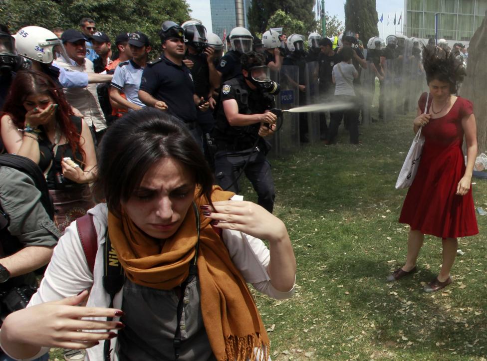 File photo of a Turkish riot policeman using tear gas against protestors in Taksim Square