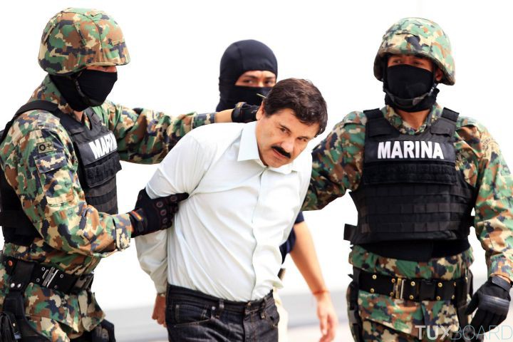 epa04096602 Mexican military hold Mexican drug lord Joaquin Guzman Loera, alias 'El Chapo' (C) at the Navy hangar in Mexico City, Mexico, 22 February 2014. The head of the Sinaloa drug cartel Joaquin 'El Chapo' Guzman was arrested on 22 February 2014 in Mazatlan in the Mexican state of Sinaloa. Reputed to be 'the most powerful drug trafficker in the world' by the United States, Guzman had been on the run for years. EPA/MARIO GUZMAN