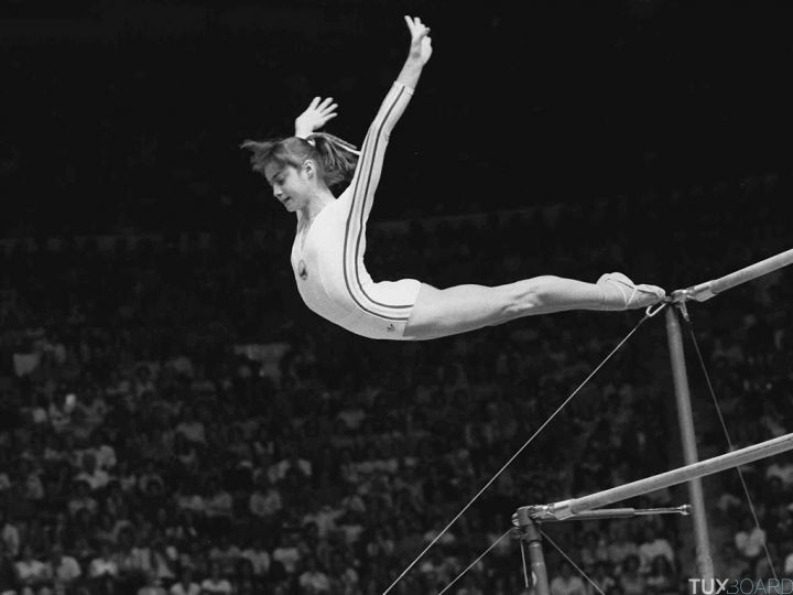 Nadia Comaneci, of Romania, dismounts from the uneven parallel bars at the Olympic Games in Montreal
