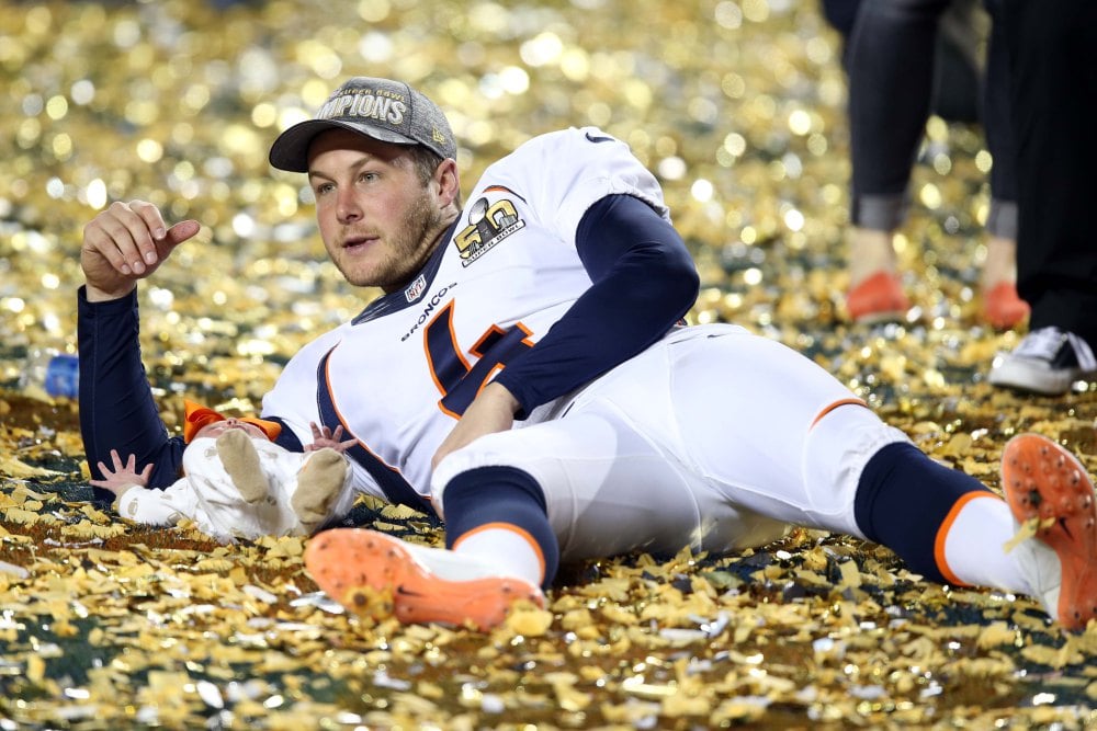 Feb 7, 2016; Santa Clara, CA, USA; Denver Broncos punter Britton Colquitt (4) lays int he confetti with his baby after beating the Carolina Panthers in Super Bowl 50 at Levi's Stadium. Mandatory Credit: Cary Edmondson-USA TODAY Sports ORG XMIT: USATSI-245820 ORIG FILE ID: 20160207_pjc_se9_320.JPG