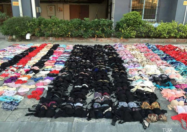 Hundreds of stolen women's underwear are placed on the ground after being found hidden in the ceiling of a apartment building, in Yulin, Guangxi Zhuang Autonomous Region, December 19, 2014. A Chinese man who stole hundreds of pieces of ladies' underwear had his secret exposed after an emergency exit ceiling where he had been storing his hoard collapsed, state media reported. The man, surnamed Tang and in his 30s, admitted to having mental problems since he was young and that he did not know how long he had been obsessed with women's undergarments, reports said. Police in the city of Yulin said they found more than 2,000 pieces of panties and bras in the roof where he had stuffed his collection. Picture taken December 19, 2014. REUTERS/Stringer (CHINA - Tags: SOCIETY CRIME LAW) CHINA OUT. NO COMMERCIAL OR EDITORIAL SALES IN CHINA
