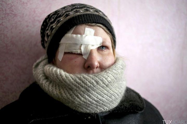 epaselect epa04623992 Yulia Novomlynets (18) waits in a line to receive the humanitarian aid in the local Palace of Culture which is used as a bomb shelter in Mironovka village, near Debaltseve of Donetsk area, Ukraine, 17 February 2015. Fighting escalates in eastern Ukraine, only hours after German Chancellor Merkel discusses the implementation of a three-day old ceasefire with Ukrainian President Poroshenko and Russian President Putin, who heads to Budapest. EPA/ANASTASIA VLASOVA
