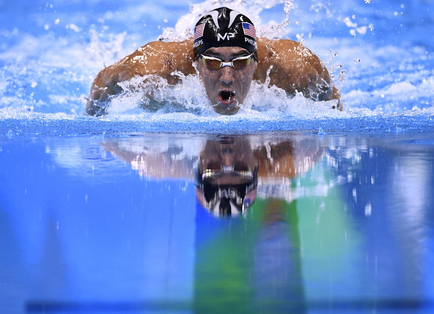 TOPSHOT - USA's Michael Phelps competes to win the Men's 200m Individual Medley Final during the swimming event at the Rio 2016 Olympic Games at the Olympic Aquatics Stadium in Rio de Janeiro on August 11, 2016. / AFP / CHRISTOPHE SIMON (Photo credit should read CHRISTOPHE SIMON/AFP/Getty Images)